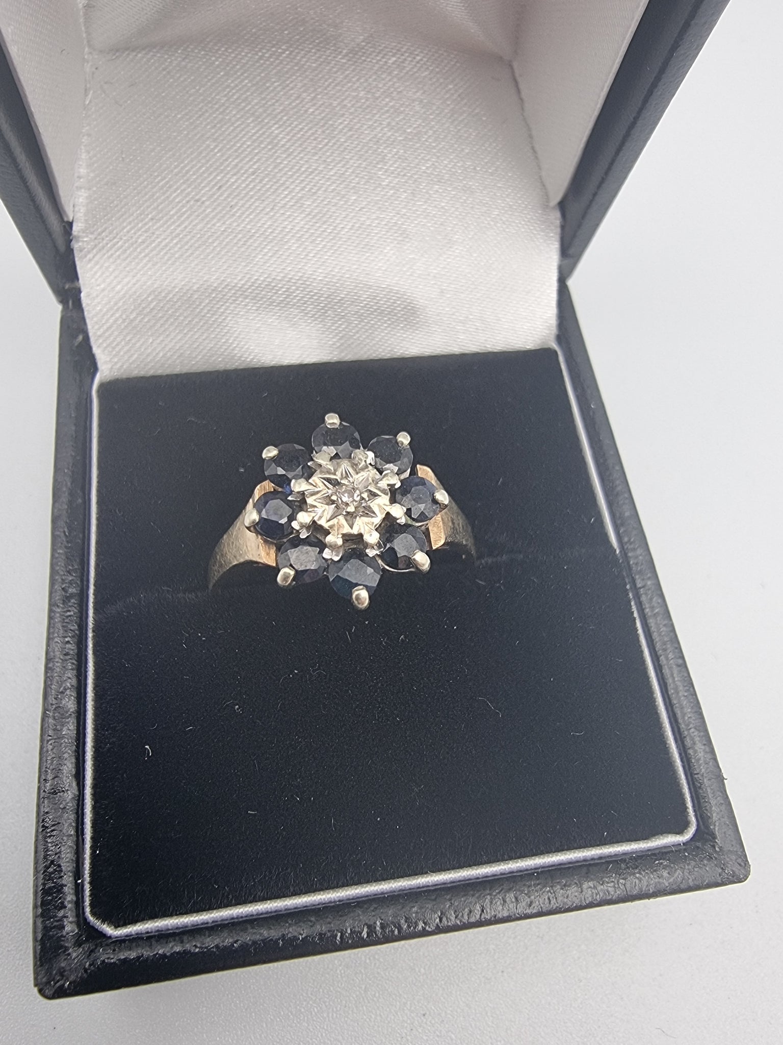 9CT Yellow gold fully hallmarked women's ring 2.85g size P with 8 black stones and cz center stone set