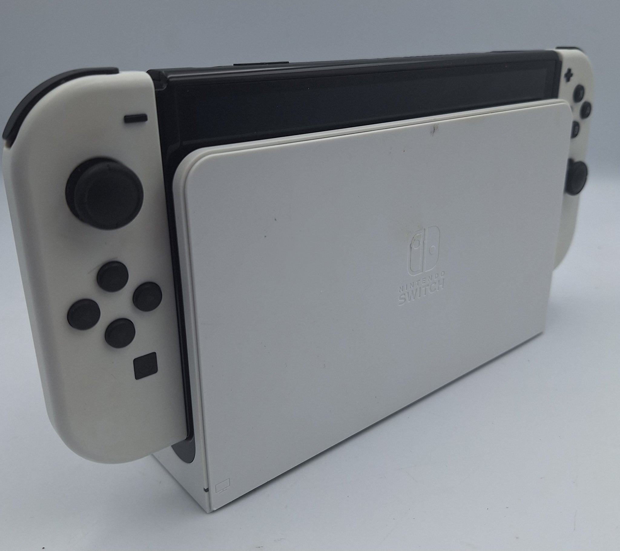 Nintendo Switch OLED 64GB black and white handheld gaming console with dock, charger and joy-con grips unboxed