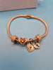 Pandora rose gold bracelet and charms.