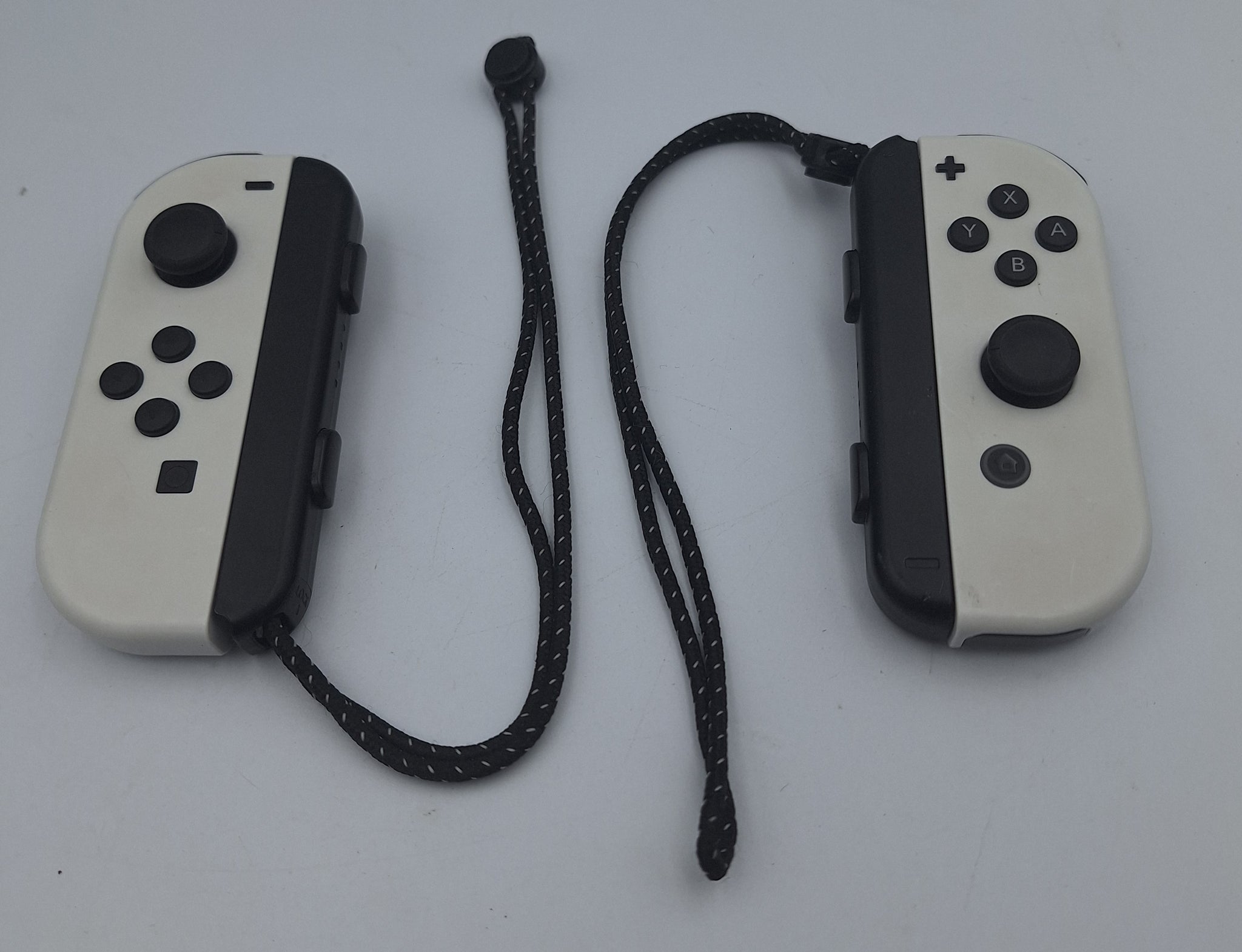 Nintendo Switch OLED 64GB black and white handheld gaming console with dock, charger and joy-con grips unboxed