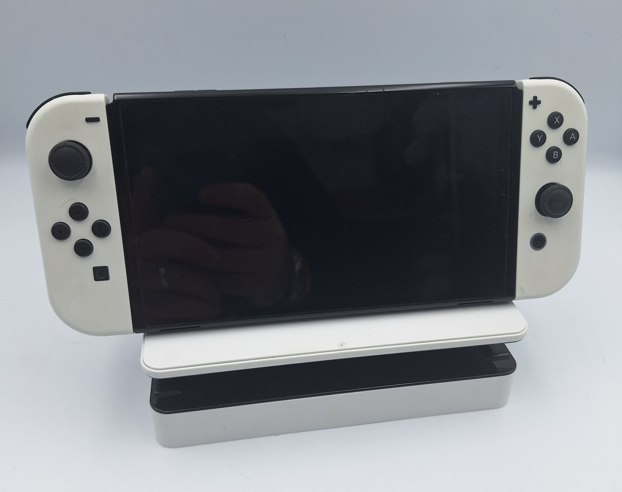 Nintendo Switch OLED 64GB black and white handheld gaming console with dock, charger and joy-con grips unboxed