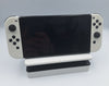 Nintendo Switch OLED 64GB black and white handheld gaming console with dock, charger and joy-con grips unboxed