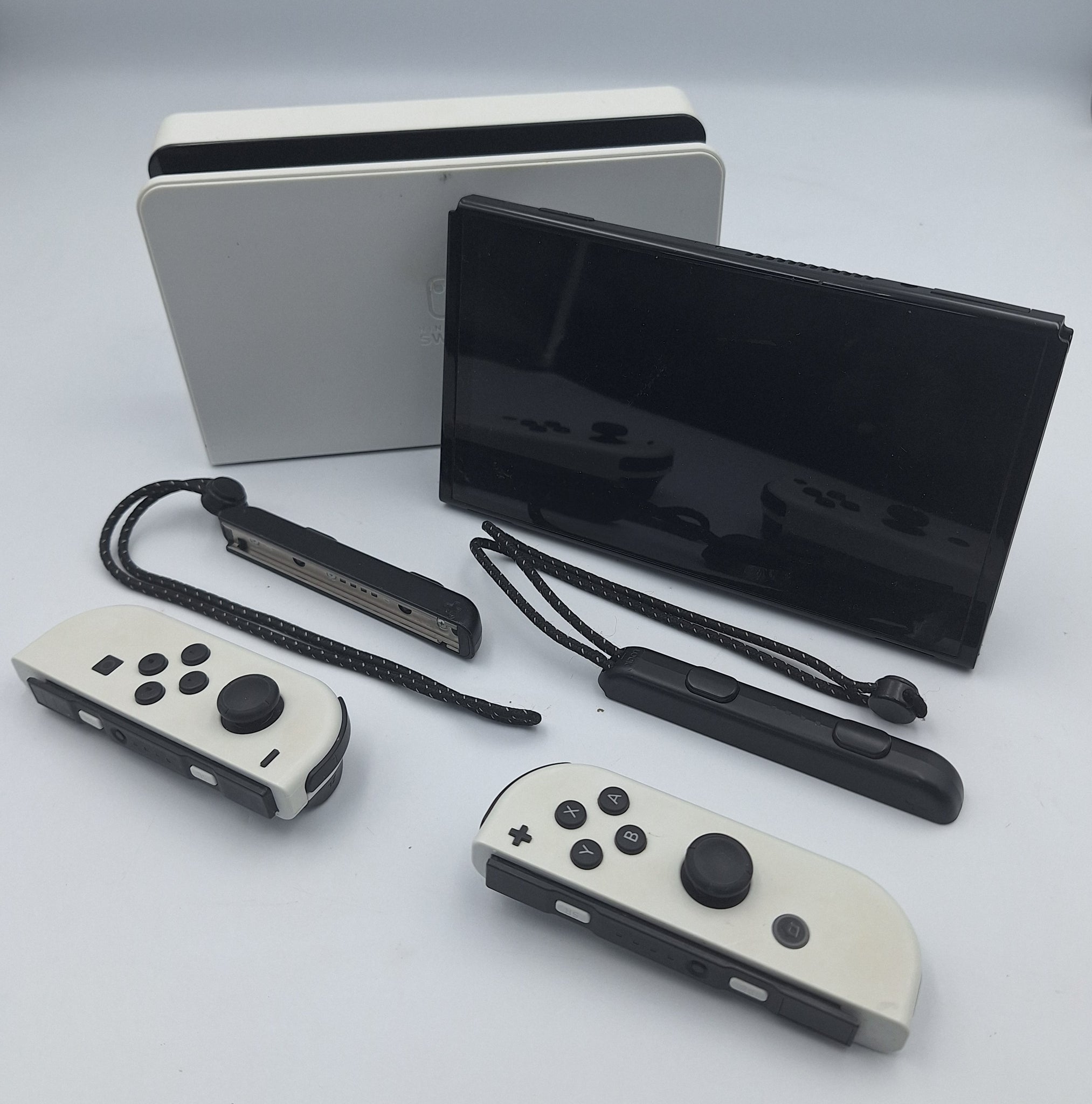 Nintendo Switch OLED 64GB black and white handheld gaming console with dock, charger and joy-con grips unboxed