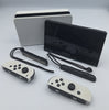Nintendo Switch OLED 64GB black and white handheld gaming console with dock, charger and joy-con grips unboxed