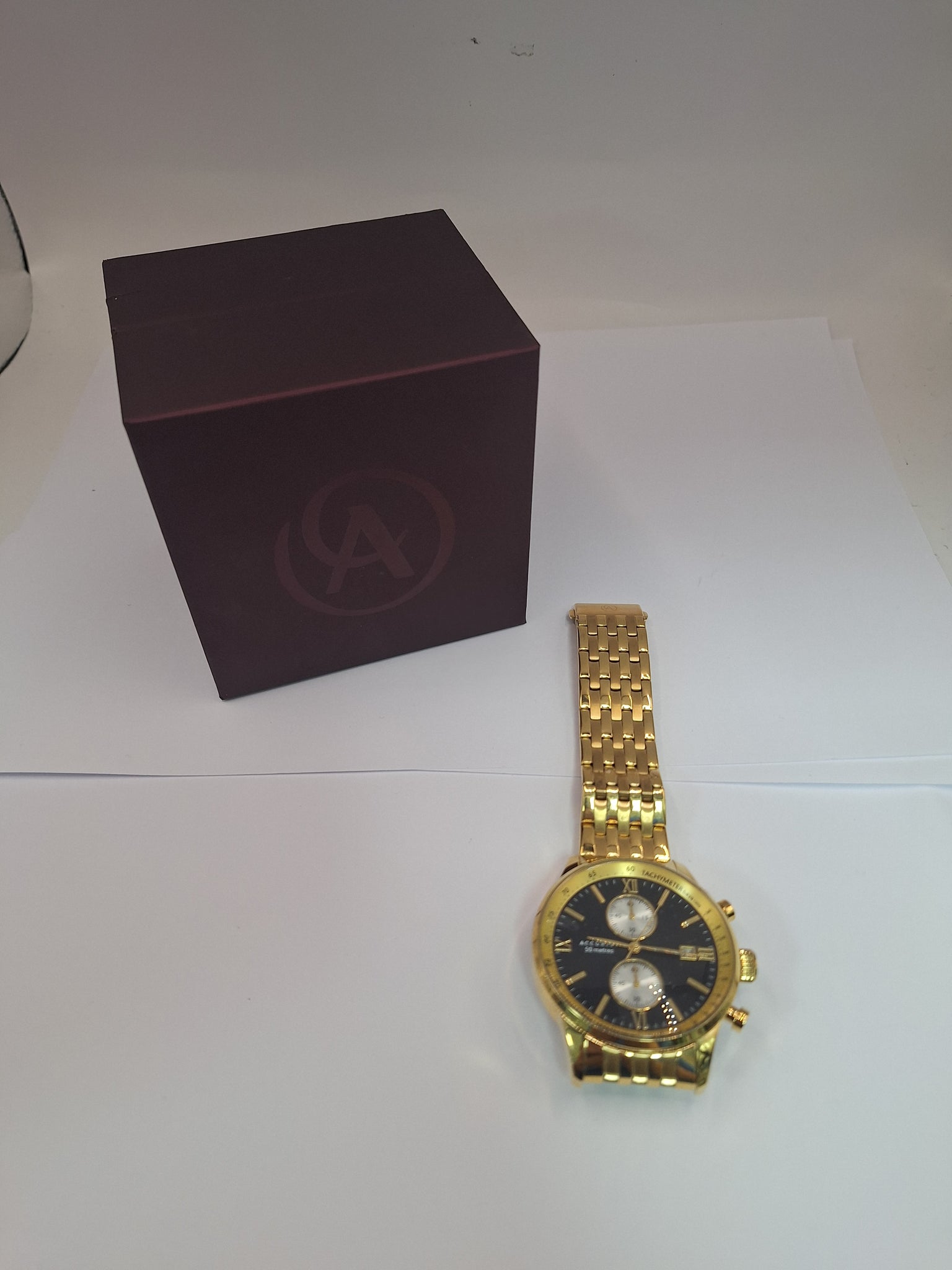 accurist 7403 chrono watch ,BRACELET STAINLESS STEEL , COMES IN ORIGINAL BOX , GOLD WITH BLACK DIAL.