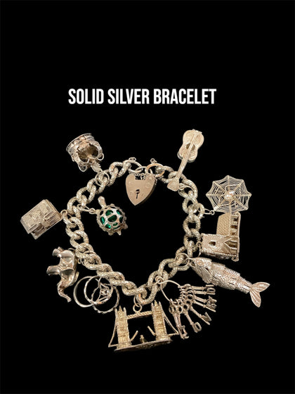 Solid silver charm bracelet with charms 72grams