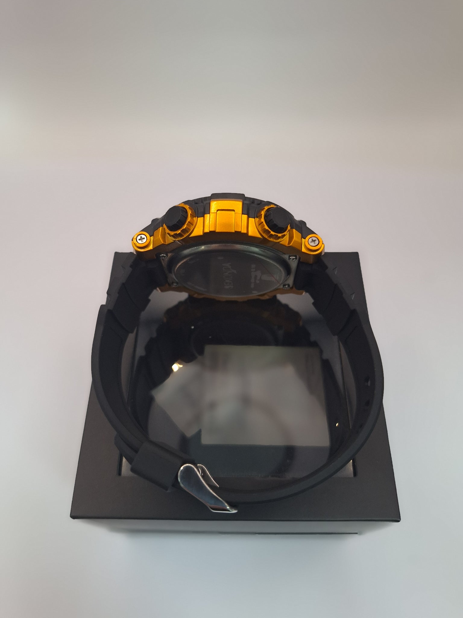 The SEKONDA 15-26 DLX is a sporty digital wristwatch featuring a black and yellow plastic case