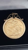 22ct Full Sovereign (7.9g) in 9ct mount/ chain (1.5g) holder. Year 1899