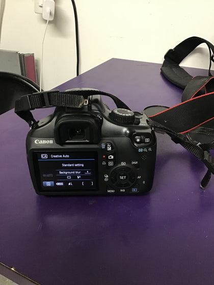Canon EOS 1100D with lens, filter, batteries, charger and bag.