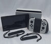 Nintendo Switch OLED White handheld 64GB console with dock grips and original charger in Nintendo carry case
