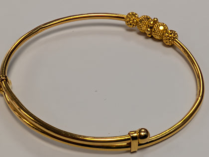 22ct gold baby bangle with patterned rollerball