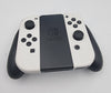 Nintendo Switch OLED 64GB white/black handheld console with hdmi dock. Original charger and joy-con cradle. Comes with carry case
