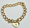 9ct yellow gold curb link bracelet with heart clasp with safety chain 7"