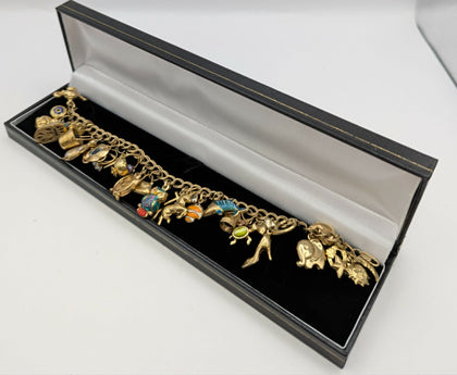 375 Hallmarked 9CT, YELLOW GOLD, 25X CHARMS ON CURBED BRACELET, 8