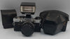 Vintage olympus OM10 35mm SLR film camera with flash attachment and travel cases