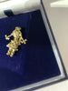 Gold pendent doll