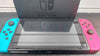 Nintendo Switch console 32GB with neon red & blue joy-con's with dose have scratch on the screen