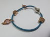 Pandora rope bracelet with 4 rose gold charns