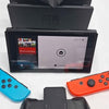 Nintendo Switch Neon 32gb console with all parts shown unboxed some slight damage to upper edge