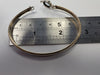 9ct gold bangle with light blue centre stone