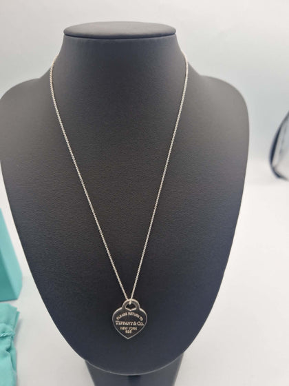 A classic Tiffany & Co. Return to Tiffany Heart Tag pendant necklace, featuring the iconic heart-shaped tag suspended from a matching sterling silver