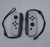 Nintendo Switch OLED White handheld 64GB console with dock grips and original charger in Nintendo carry case