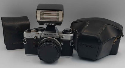 Vintage olympus OM10 35mm SLR film camera with flash attachment and travel cases