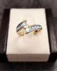 9ct Yellow Gold Crossover Ring Channel set with Light Blue Stones - Size M