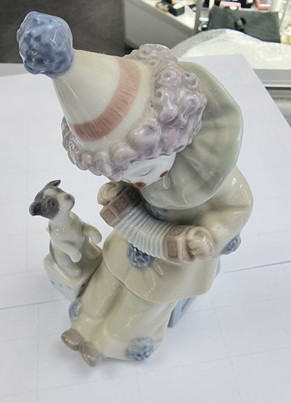 A Lladro Clown 5279, with Concertina and Playing With Puppy.