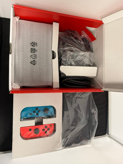 nintendo switch oled boxed red and blue joycon