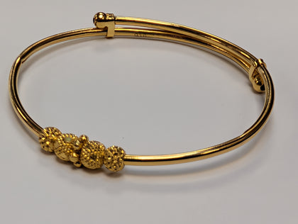 22ct gold baby bangle with patterned rollerball