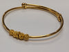 22ct gold baby bangle with patterned rollerball