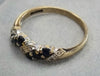 9CT GOLD RING WITH DARK BLUE STONES