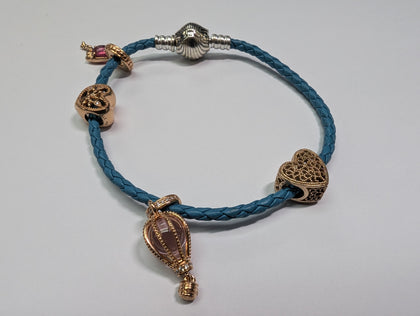 Pandora rope bracelet with 4 rose gold charns