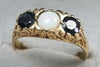 9CT GOLD RING WITH BLACK AND WHITE STONE