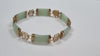 9CT GOLD & GREEN STONE BRACELET 19CM