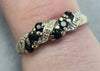 9CT GOLD RING WITH DARK BLUE STONES