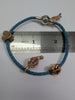 Pandora rope bracelet with 4 rose gold charns