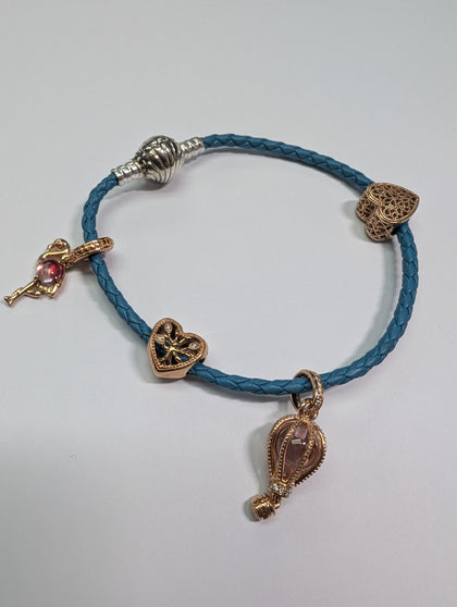 Pandora rope bracelet with 4 rose gold charns