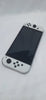 Nintendo Switch OLED White handheld 64GB console with dock grips and original charger in Nintendo carry case