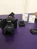 Canon EOS 550D SLR Digital Camera with 18-55mm lens, 2 batteries and a charger.