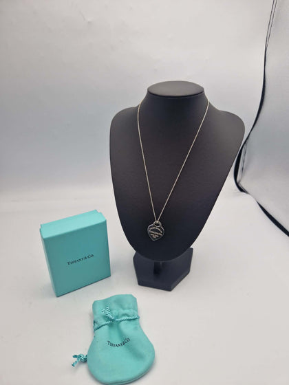 A classic Tiffany & Co. Return to Tiffany Heart Tag pendant necklace, featuring the iconic heart-shaped tag suspended from a matching sterling silver