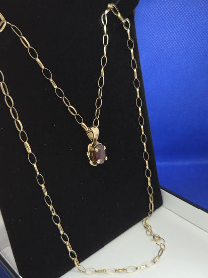 Hallmarked 375 and tested 9K , 6.4 grams gold link chain , Red stone  . 22