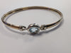 9ct gold bangle with light blue centre stone