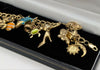 375 Hallmarked 9CT, YELLOW GOLD, 25X CHARMS ON CURBED BRACELET, 8", 35.1G, BOXED