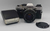 Vintage olympus OM10 35mm SLR film camera with flash attachment and travel cases