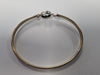 9ct gold bangle with light blue centre stone