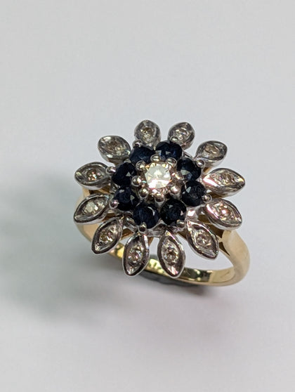18CT GOLD DIAMOND FLOWER RING WITH BLACK STONES