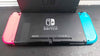 Nintendo Switch console 32GB with neon red & blue joy-con's with dose have scratch on the screen